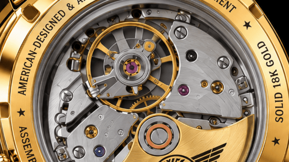 Close up of AVIGO luxury watch movement with gold accents and intricate mechanics 