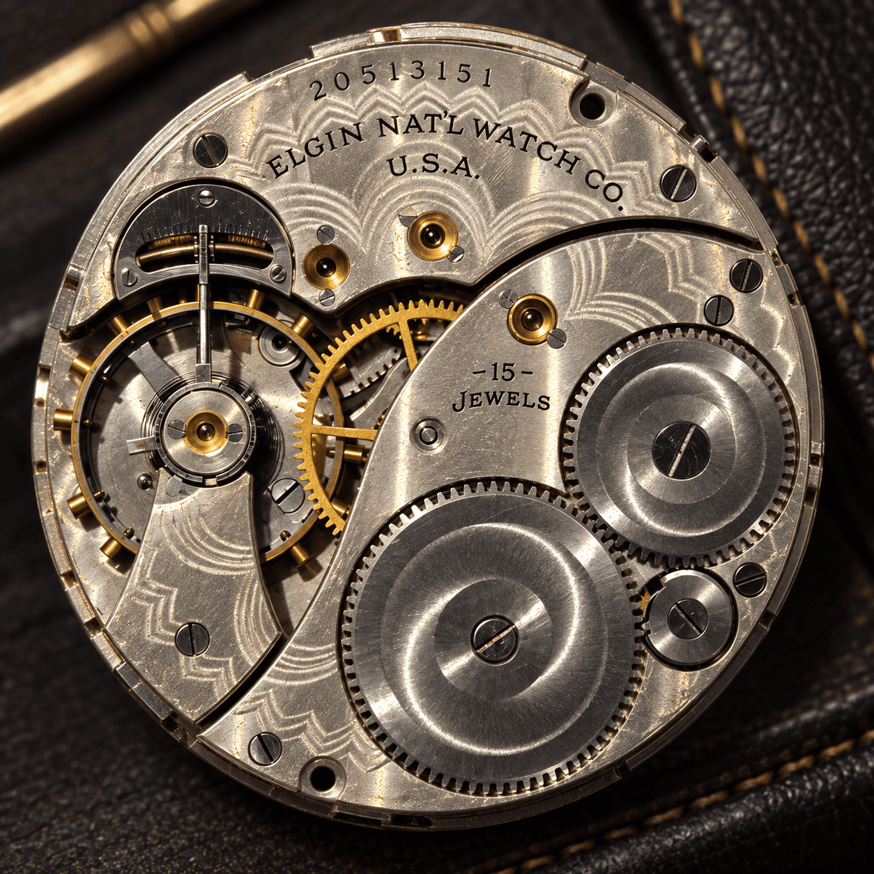 Close up of Elgin watch movement with intricate gears and engravings 