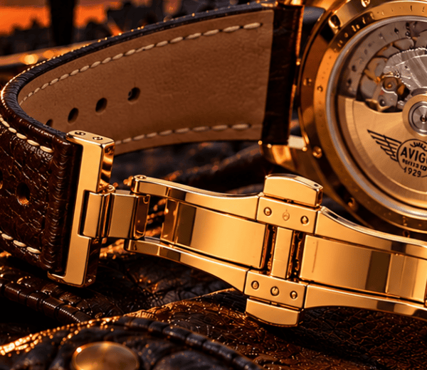 Close up of AVIGO luxury watch with gold case and leather strap 