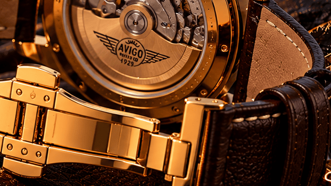 Close up of AVIGO luxury watch with gold case and leather strap 
